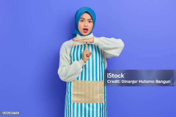 Portrait Of Shocked Young Housewife Woman In Hijab And Apron Showing Time Out Gesture With Hands Isolated On Purple Background People Housewife Muslim Lifestyle Concept Stock Photo - Download Image Now