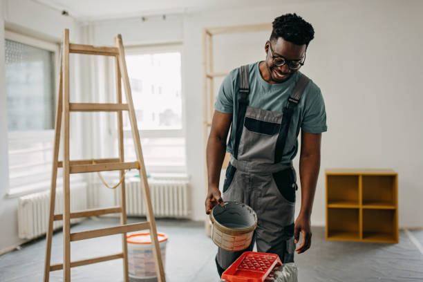 istock African-American professional painter paints the wall indoors 1372512715
