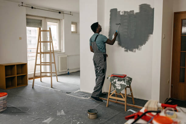 istock African-American professional painter paints the wall indoors 1372512753