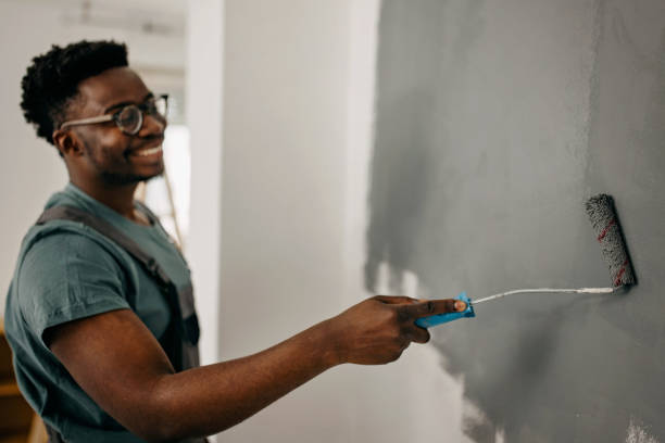 istock African-American professional painter paints the wall indoors 1372512763