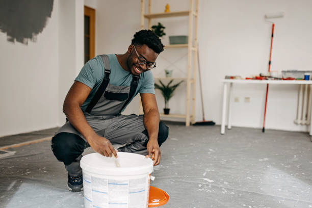 istock African-American professional painter paints the wall indoors 1372512818