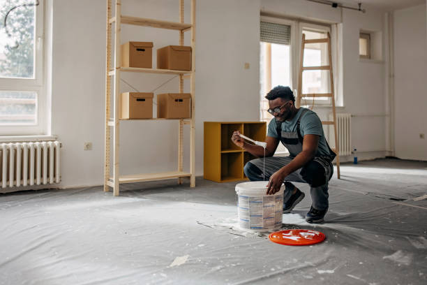 istock African-American professional painter paints the wall indoors 1372512822