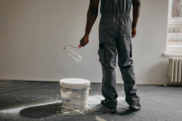 istock African-American professional painter paints the wall indoors 1372512925
