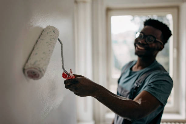 istock African-American professional painter paints the wall indoors 1372512991