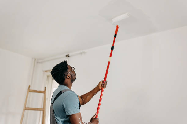 istock African-American professional painter paints the ceiling indoors 1372513035