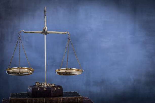 istock Justice scale with blue highlight in the background. 1372513073
