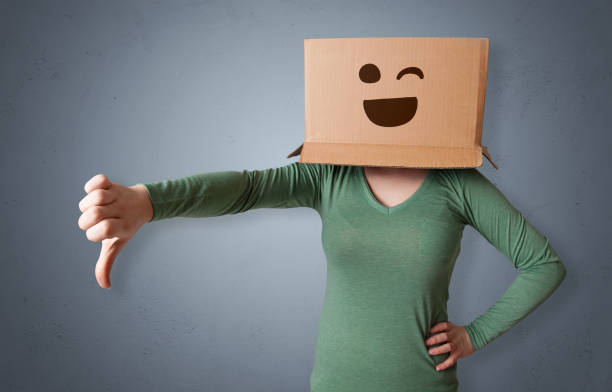 istock Funny woman smiling with cardboard box head 1372516269