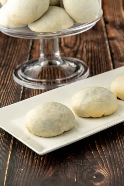 Photo of Delicious izmir bomb or izmir bombasi on a white plate on wooden table