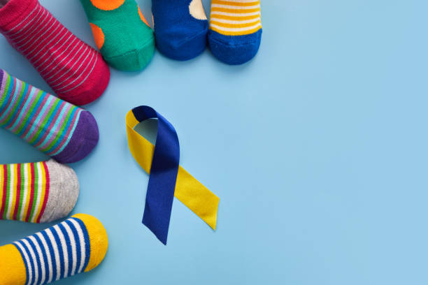 world down syndrome day background. down syndrome awareness concept. socks and ribbon on blue background - downs syndrome work bildbanksfoton och bilder