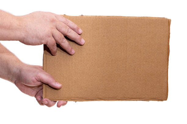 istock Hands holding a cardboard sign without any legend from the side. 1372521167