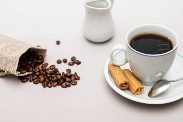 istock Coffee cup with biscuits, milk jug and coffee beans 1372521292