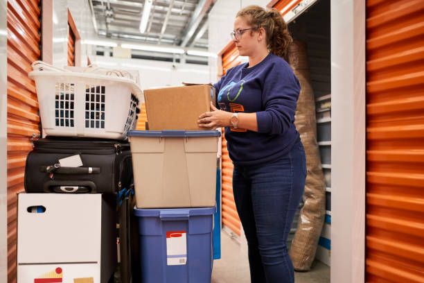 istock Woman moving boxes at self storage unit 1372522128