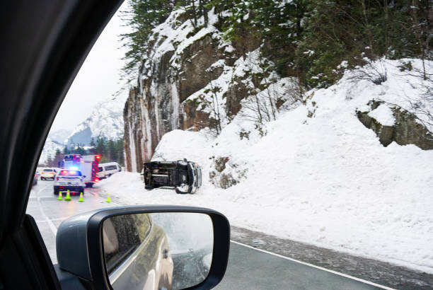Car driving by a roadside accident on a highway in winter
