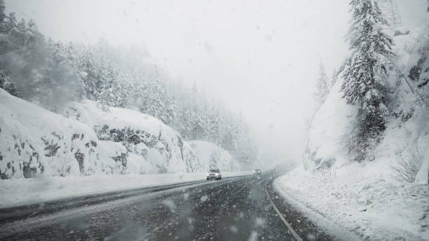 istock Snowstorm on a highway running through the countryside 1372522251