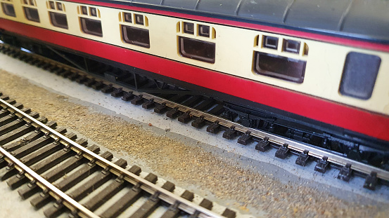 Red model railway carriage and tracks