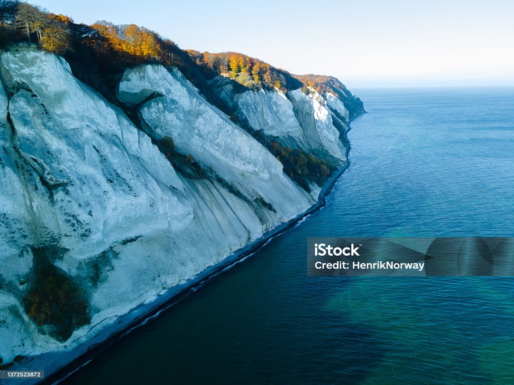 Iconic Møns Klint in Denmark on a sunny autumns day. White chalk cliffs on the Baltic coast  aerial photo. Aerial View Stock Photo