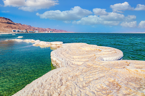 The drainless salt lake in the Middle East. Dead Sea. Israel. Evaporated salt forms beautiful, symmetrical crystals on the surface of the water. The saltiest lake in the world.