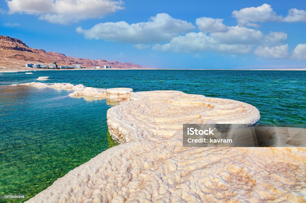 The beautiful, symmetrical crystals The drainless salt lake in the Middle East. Dead Sea. Israel. Evaporated salt forms beautiful, symmetrical crystals on the surface of the water. The saltiest lake in the world. Israel Stock Photo