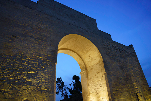 Lecce, Apulia, Italy: Porta Napoli, historic door with arch at evening