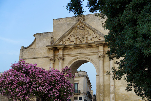 Lecce, Apulia, Italy: Porta Napoli, historic door with arch at evening