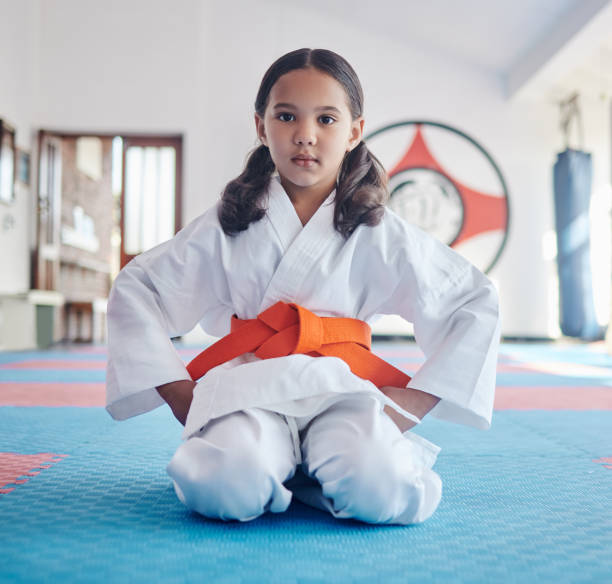 Shot of a cute little girl practicing karate in a studio