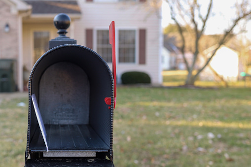A white envelope inside of a mailbox