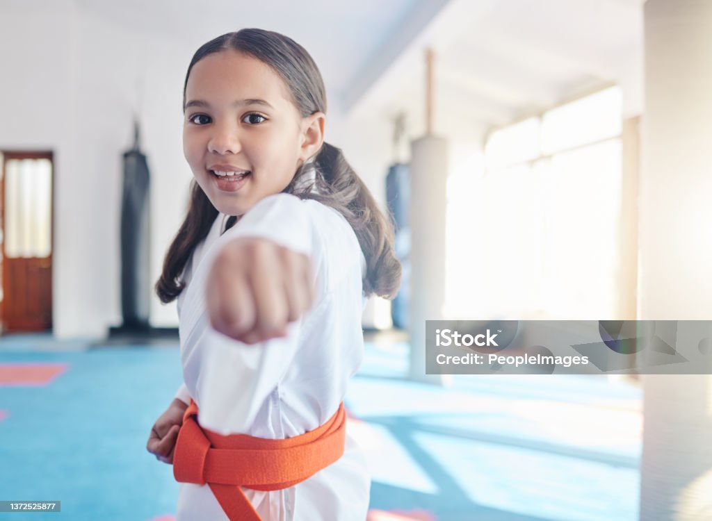 Shot of a cute little girl practicing karate in a studio A little girl learning big lessons Child Stock Photo