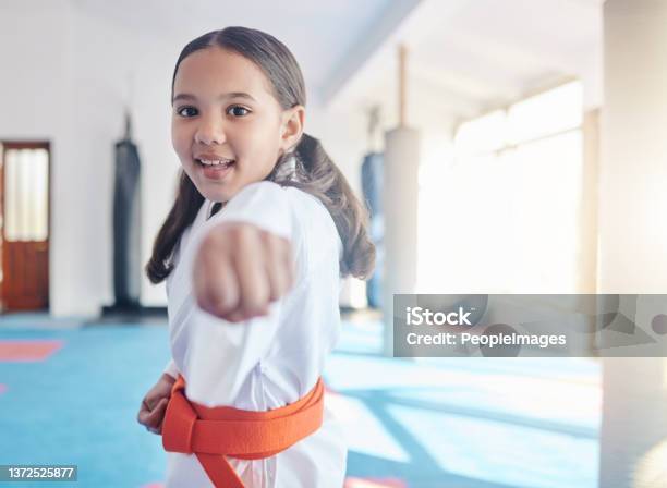 Shot Of A Cute Little Girl Practicing Karate In A Studio Stock Photo - Download Image Now