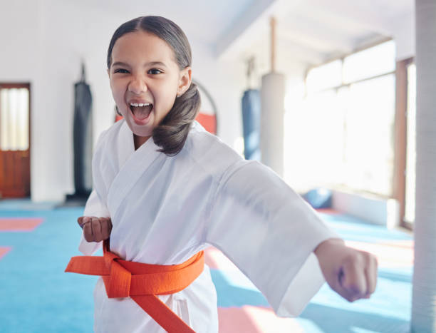 Shot of a cute little girl practicing karate in a studio Beat 'em to the punch karate stock pictures, royalty-free photos & images