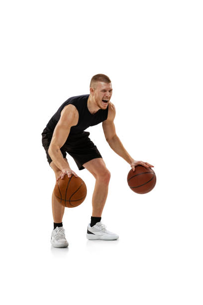 istock Handsome muscled man, basketball player posing with two balls isolated on white studio background. Sport, motion, activity concepts. 1372526796