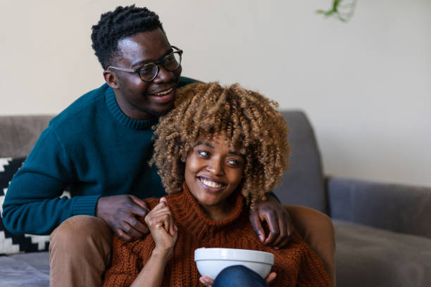istock The couple is relaxing on the sofa and watching tv 1372527092