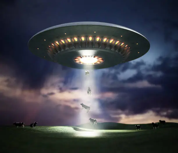 Photo of 3D illustration of retro UFO hovering in the sky using a tractor beam on the cows