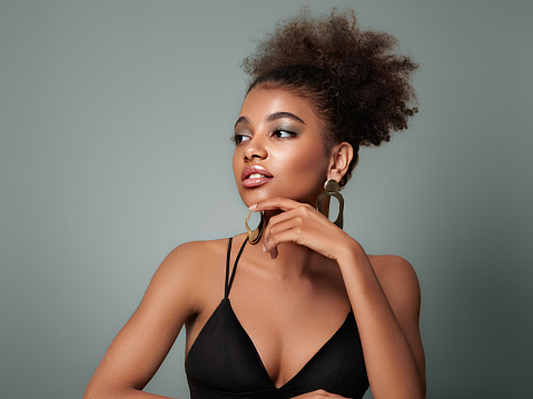 Happy, smile and natural beauty of a black woman with happiness in a studio with mockup. Smiling young female model from Mexico with a positive face expression and white background with mock up space