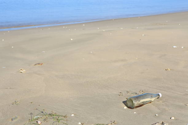 istock sea. Beach. glass bottle. garbage. background. 1372533532