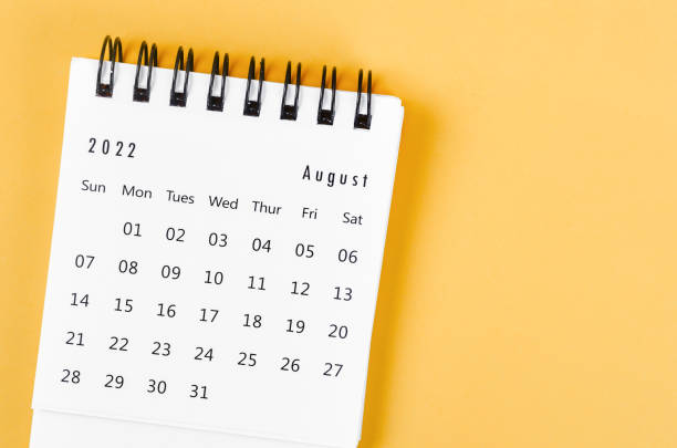 istock August 2022 desk calendar on light yellow background. 1372534240
