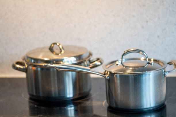 istock Two stainless steel pans on an electric hob. 1372538172
