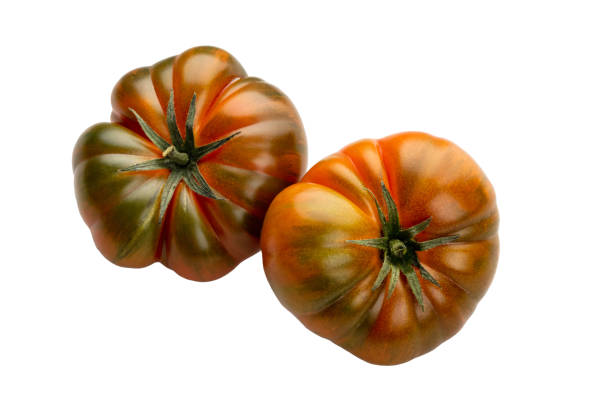 istock Heirloom tomato isolated on white background. Tomato clipping path. 1372538454