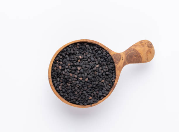 istock Bio natural black sesame seeds on wooden spoon. 1372538469