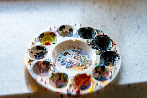 Old dried paint on a plastic moulded paint palette.