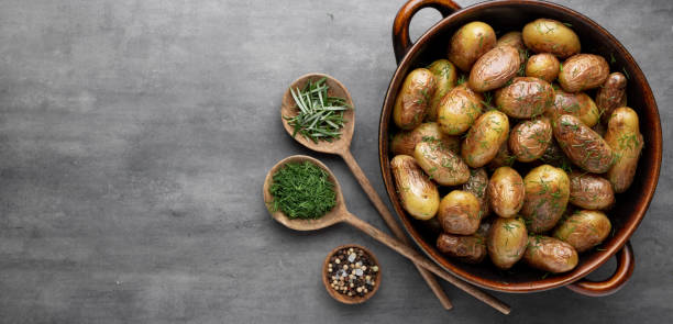 istock Pan filled with roasted potatoes shot on rustic wooden table. 1372538542