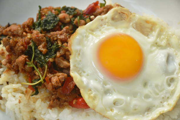 istock stir-fried spicy chop pork with basil leaf topping egg on rice 1372539610