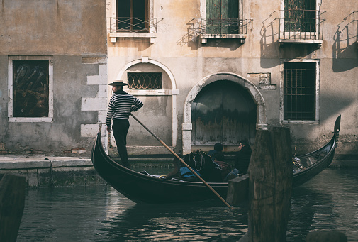 Gondola ride on a canal of Venice in Italy, view from the gondola