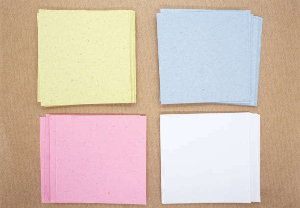 stacks of square paper notes on kraft paper background. multicolored paper sheets. mockup for design. blank templates. - paper stack heap index card imagens e fotografias de stock