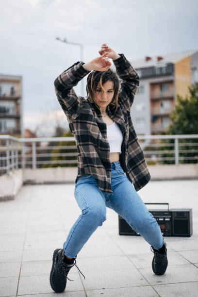 istock Teeange girl is dancing on the rooftop 1372549245