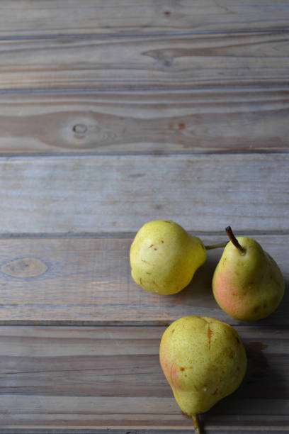 istock fresh pears on wooden background 1372549681