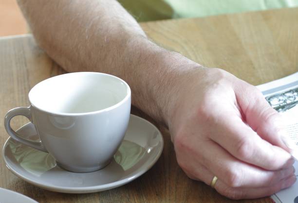 istock Married man reads newspaper at breakfast 1372554242
