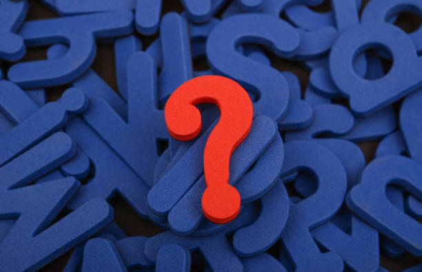 istock Red question mark on a background of blue alphabet 1372557661