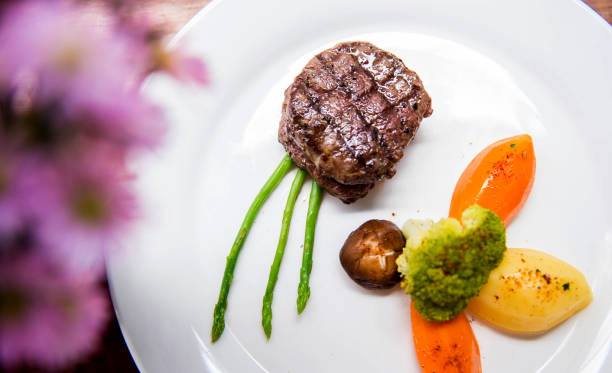 Tenderloin steak grilled served in a white plate fine dining restaurant