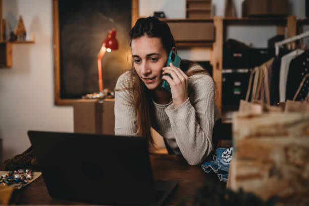 istock A woman is checking her laptop while she's talking at the phone 1372559853