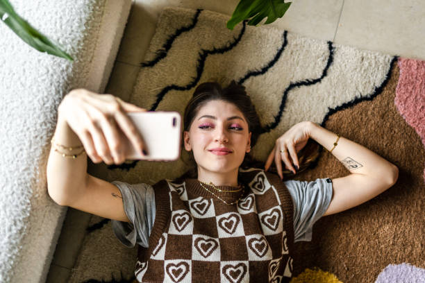 Young woman taking selfie for social media stock photo